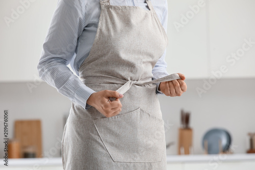 Person tying a beige linen ...