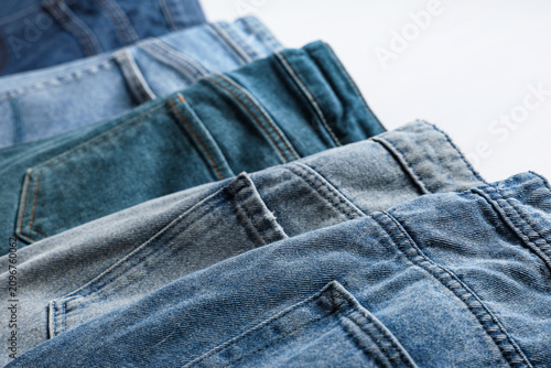 Stack of blue denim jeans i...