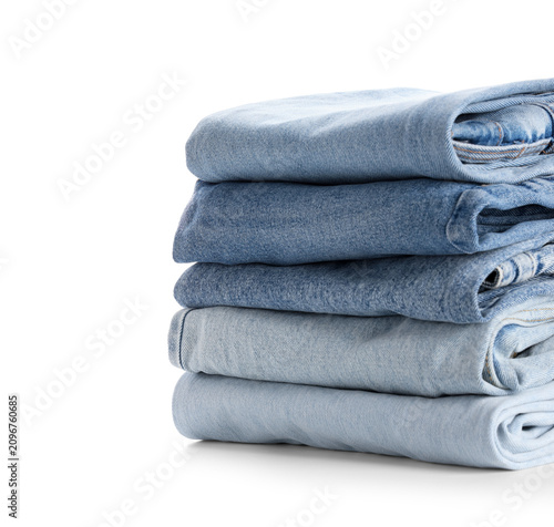 Bild auf Leinwand Stack of folded blue denim jeans in various shades, casual fashion and clothing
