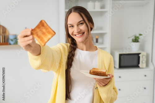 Smiling young woman holding...