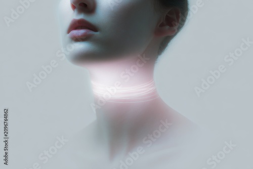 Soft minimal portrait with bright throat light ring around neck for background and poster design about silence and voice