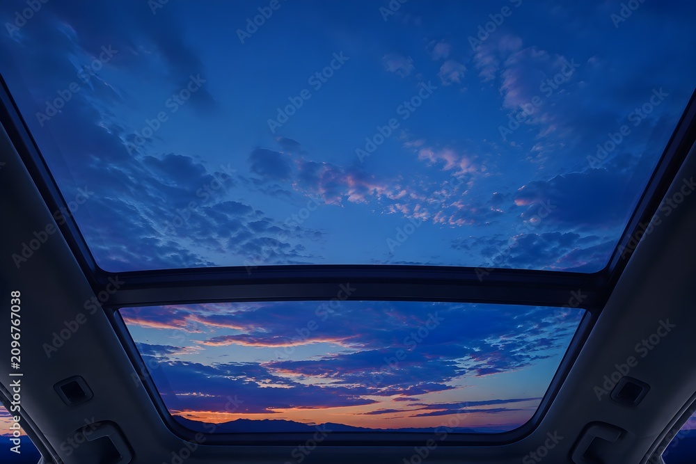Fototapeta premium Glass Sunroof Rests Beneath Vivid Blue Twilight in Elegant Automotive Landscape Photography Scene Composition Design