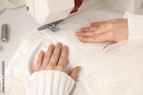 Female tailors hands sewing...