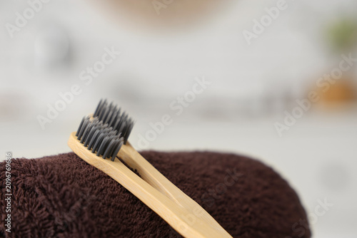 Toothbrushes on towel in ba...