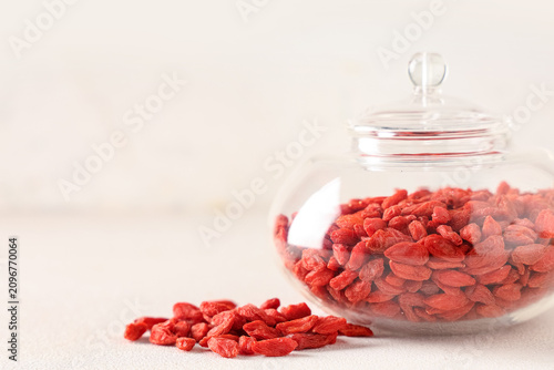 Foto Jar with dried goji berries on white background, closeup