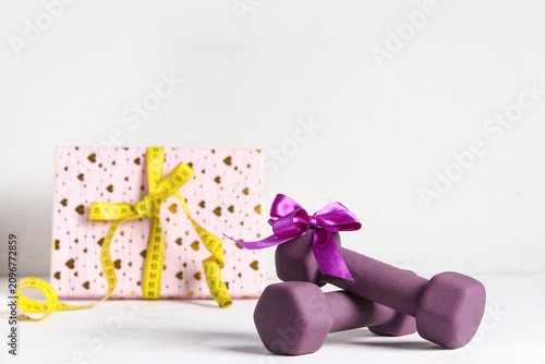 Purple dumbbells with bow a...