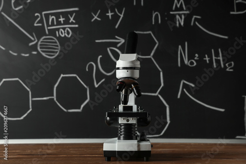 Modern microscope on wooden...
