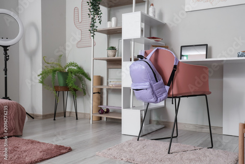 Lilac backpack on chair in ...