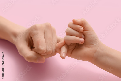 Child and woman making pink...