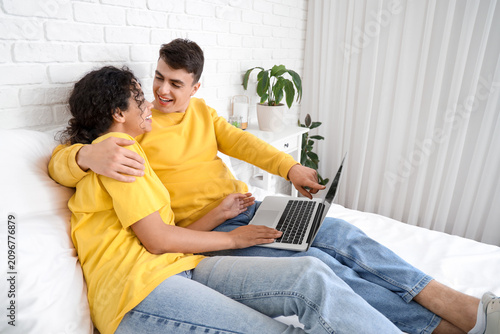 Young loving couple using l...