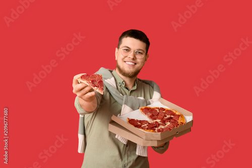 Young man holding cardboard...