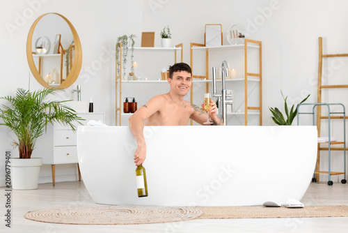 Young man with champagne ta...