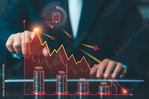 Businessman pointing at declining red financial graph with falling stack of coins and purchase order warning icon, economic recession concept.