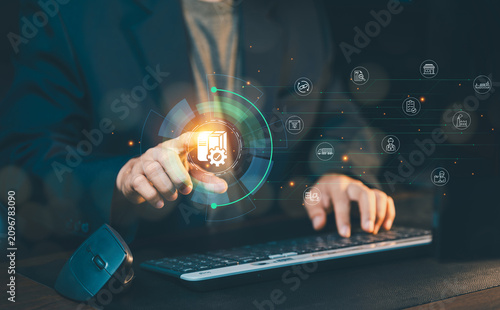 Businessman using keyboard with virtual smart warehouse logistics supply chain management interface, automated industrial operation concept.