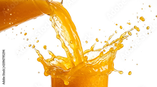 Bright orange juice pouring from a glass pitcher into a glass, creating dynamic liquid splashes and droplets against a plain white background