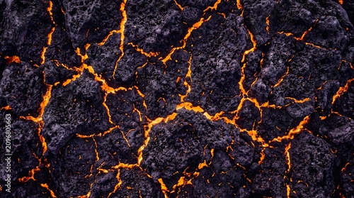 Molten lava flowing through volcanic rock, geological formation and geothermal energy halloween concept, texture background, copy space