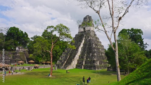 Temple of the Great Jaguar rising above plaza with visitors, Tikal