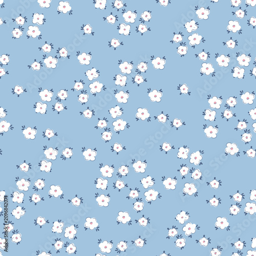 Obraz na plátne Cute floral seamless pattern background with tiny white flowers on light blue backdrop