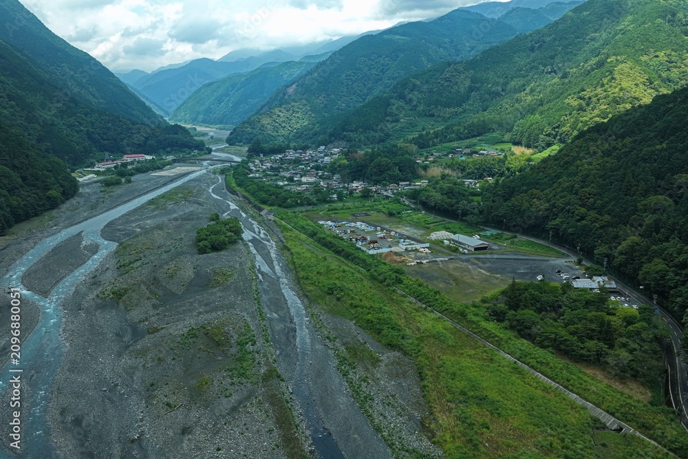 Obraz premium Aerial drone photo of mountain valley river and village in Abe River area, Shizuoka, Japan