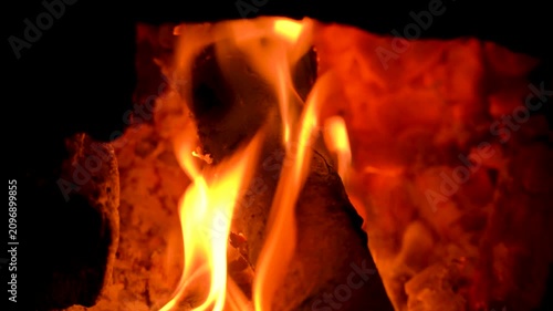Close-up of Bright Orange Flames Burning on Wood Logs in Fireplace