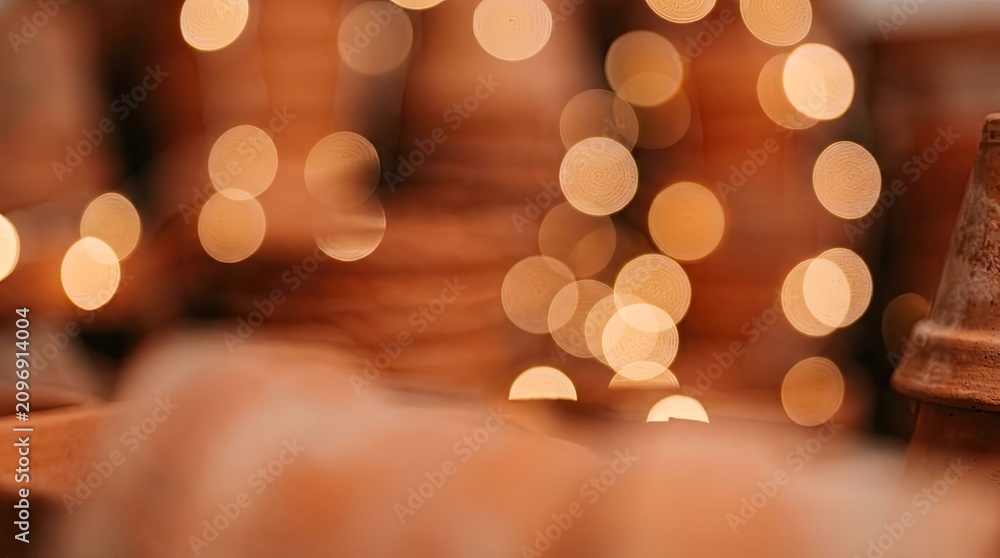 Fototapeta premium Festive bokeh background with warm glowing lights and rustic terracotta colors.