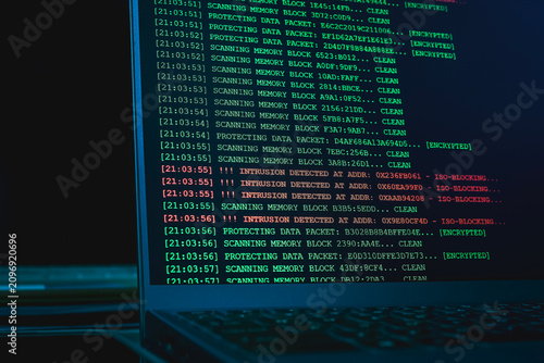 Laptop screen displaying cyber intrusion detected alert logs in terminal interface. Concept of hacking attack, network defense failure, cyber security breach, and data firewall monitoring.