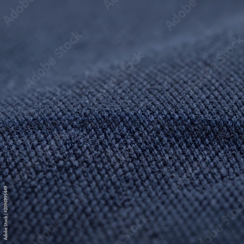 Dark blue denim fabric texture close-up. Heavy cotton twill weave for fashion design and apparel manufacturing.