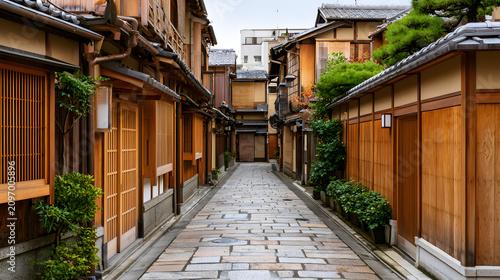 Narrow Stone Paved Alley in Gion District with Traditional Wooden Houses and Lush Greenery