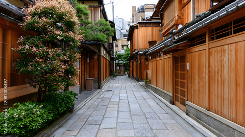 Narrow Stone Paved Alley in Gion District Lined with Traditional Wooden Houses and Greenery