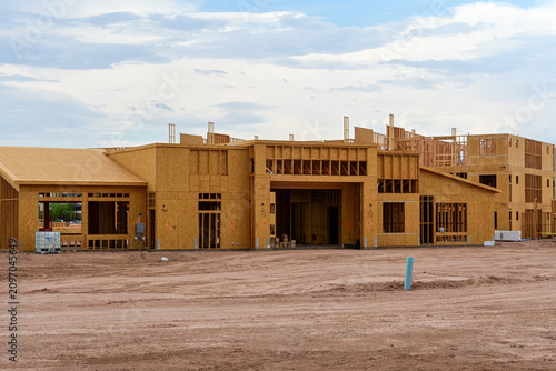 Fotografía Apartment complex main building under construction with wood framing, illustrati