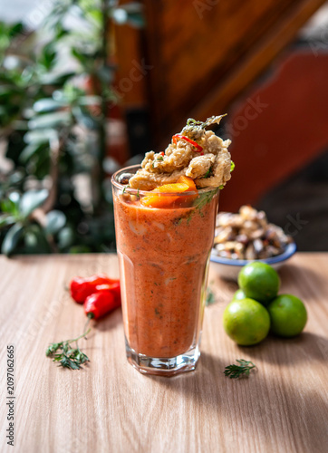 Traditional Peruvian leche de tigre, a flavorful citrus-based seafood preparation made with fish, lime juice, red onion, chili and aromatic herbs, representing the vibrant flavors of Peruvian cuisine.