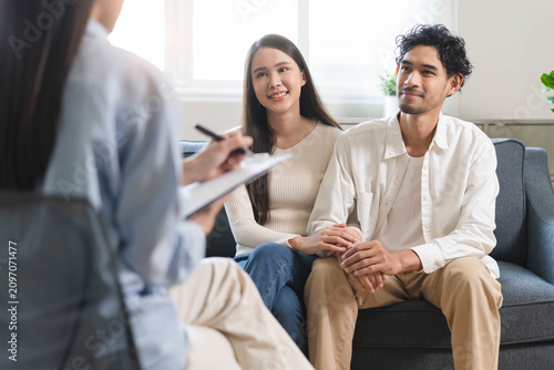 Spouses relationship consultant concept, Married couple listen to psychologist  during therapy talk session for married couple that mental health breakdown and relationship problems.