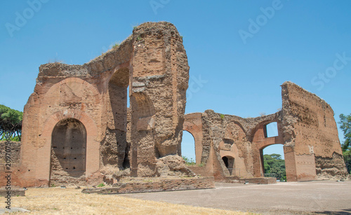 Massive ancient brick walls and soaring arches of the Baths of Caracalla in Rome, Italy