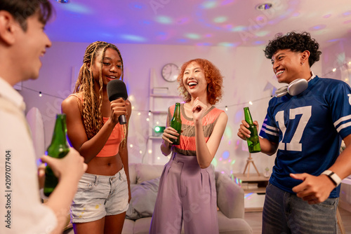 Group of diverse Generation Z friends enjoying a party in a cozy house. 