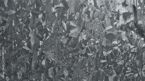 Close-up of a shimmering galvanized metal surface with intricate spangle patterns, showcasing a rugged and durable industrial texture and abstract background