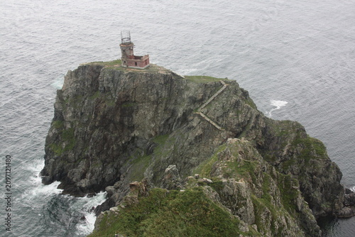 Canvas Print Lighthouse standing on a rocky sea cliff, coastal landscape, dramatic nature, travel destination, maritime landmark
