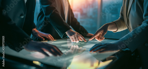 Business Team Collaborating on Interactive Touchscreen Table