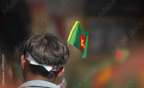 Dhaka, Bangladesh- 16 Dec 2025; Historical 1971 Bangladesh flag with map held during national day celebration.