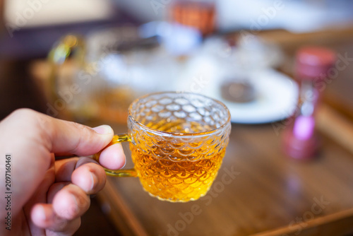 Holding a cup of tea in a cafe. A Japanese-style decorated tea shop. The warm atmosphere is perfect for relaxation.