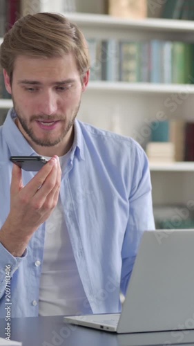 Man feeling Angry on Smartphone while using Laptop, Vertical Video