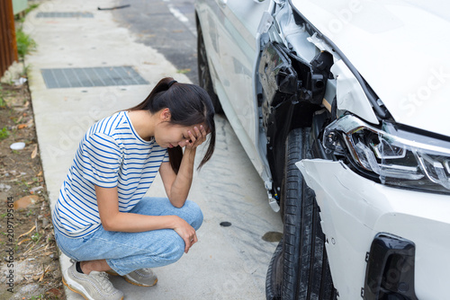 Woman stressed after car accident on road
