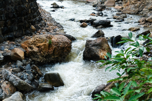 Flowing stream over rocks in a natural landscape