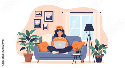 Young woman freelancer working on her laptop while sitting comfortably on a blue sofa with her cute pet cat in a cozy home office.