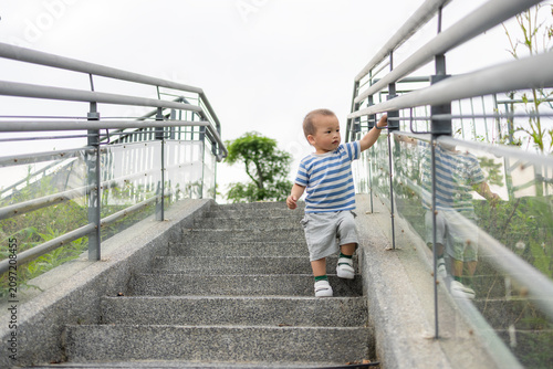 Small child going down stairs at outdoor