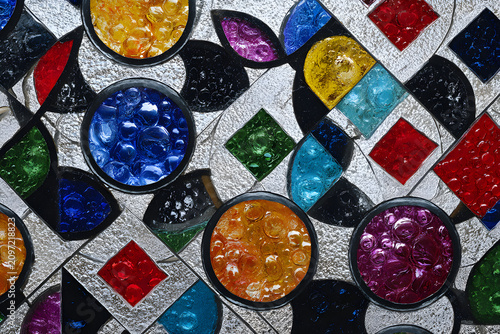 Overhead glass mosaic wallpaper featuring geometric circles textured panes and lively multicolor fragments
