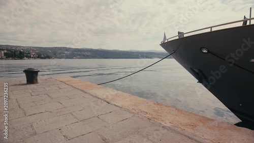 The bow of a luxury motor yacht is moored along the waterfront overlooking the Adriatic Sea in Opatija Croatia.