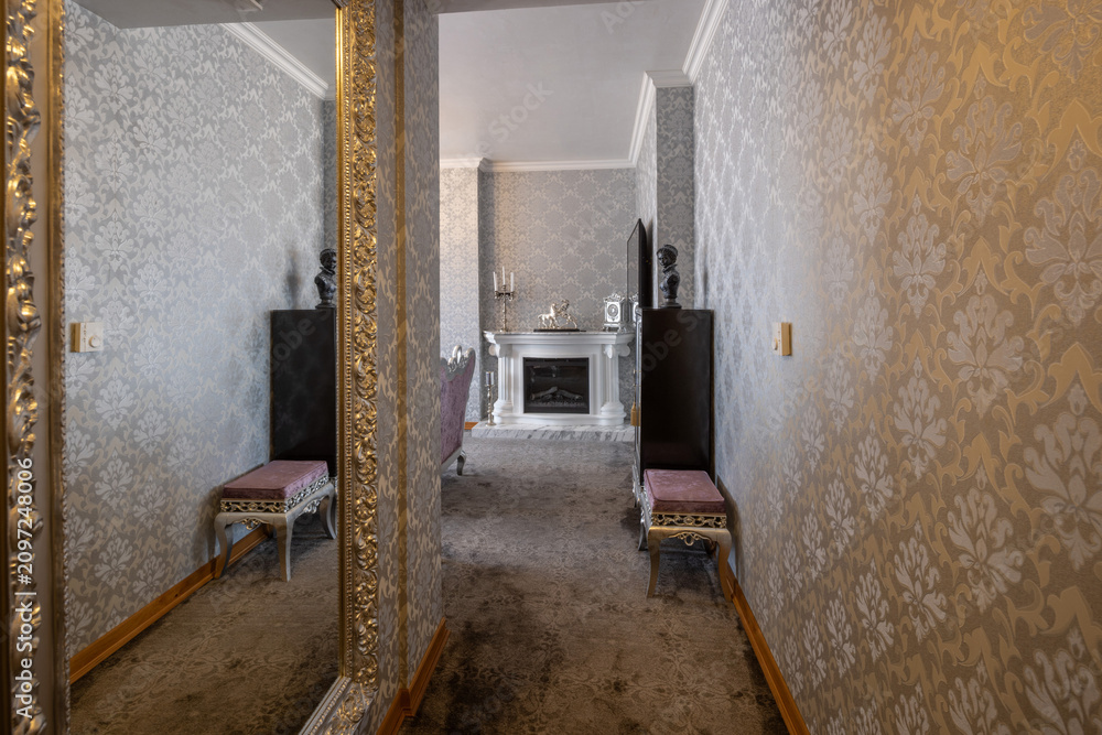 Obraz premium Luxury corridor interior with baroque wallpaper elegant gold framed mirror and fireplace