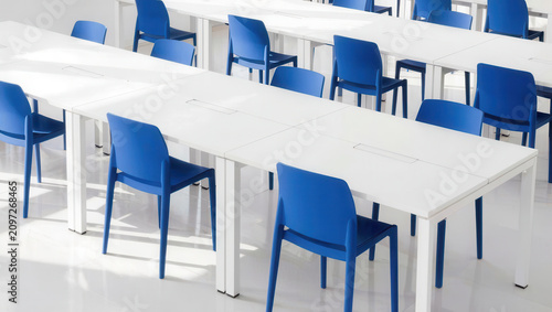 Empty classroom, blue chair, white table, bright interior, modern room, school furniture