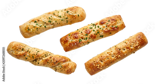 Foto Four golden brown garlic herb breadsticks with flaky sea salt and parsley