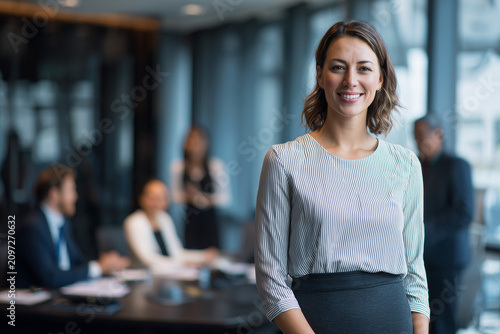 Young attractive CEO, elegant skirt, elegant boardroom, executive vision presentation, entrepreneurial success, premium executive portrait.